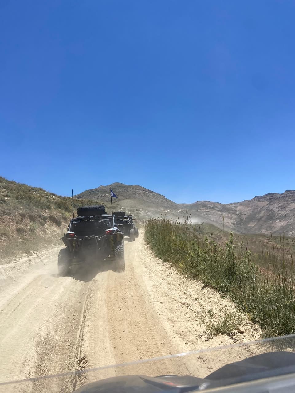 Point of view shot following a Can-Am up a dirt track