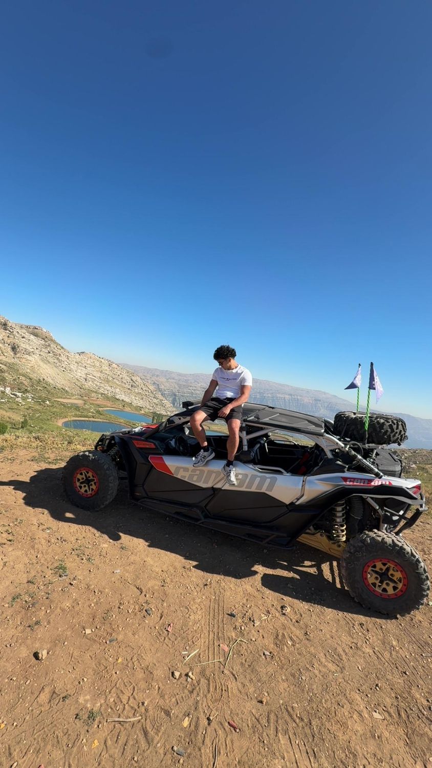 Rider sitting on an X3 at a summit