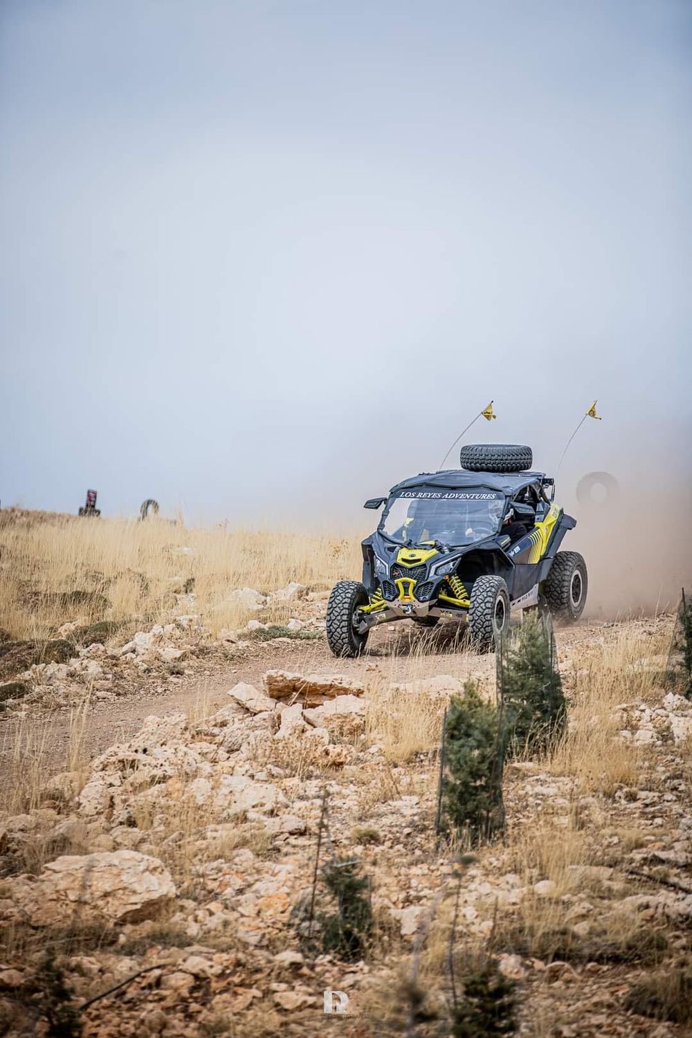 Can-Am X3 kicking up dust on a mountain trail